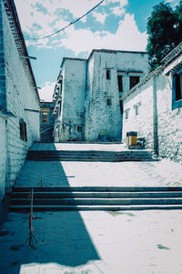 Snow covered buildings against sky