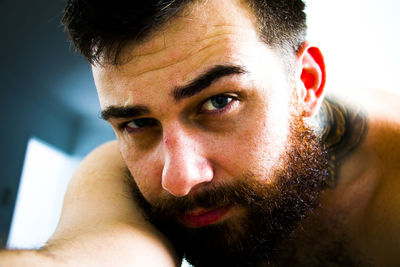 Close-up portrait of young man using mobile phone