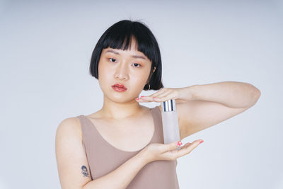 Portrait of a beautiful young woman over white background