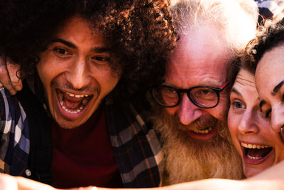 Playful melting pot diverse friends share a joyful selfie moment