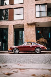 Car on street against building in city