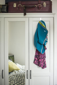 Clothes hanging on door at home
