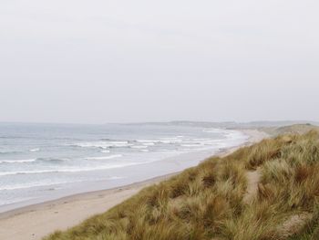 Scenic view of beach against clear sky