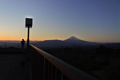 Scenic view of mountains against clear sky at sunset