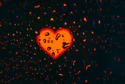 Close-up of illuminated pumpkin against gray background