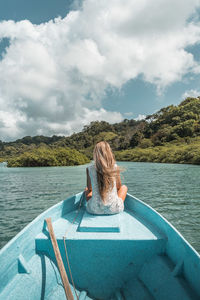 Rear view of woman looking at sea against sky