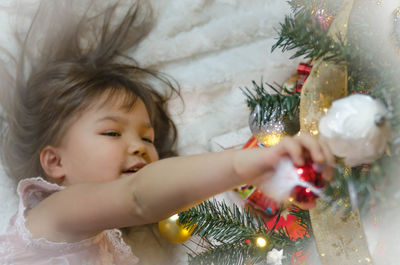 Midsection of woman with christmas tree at home