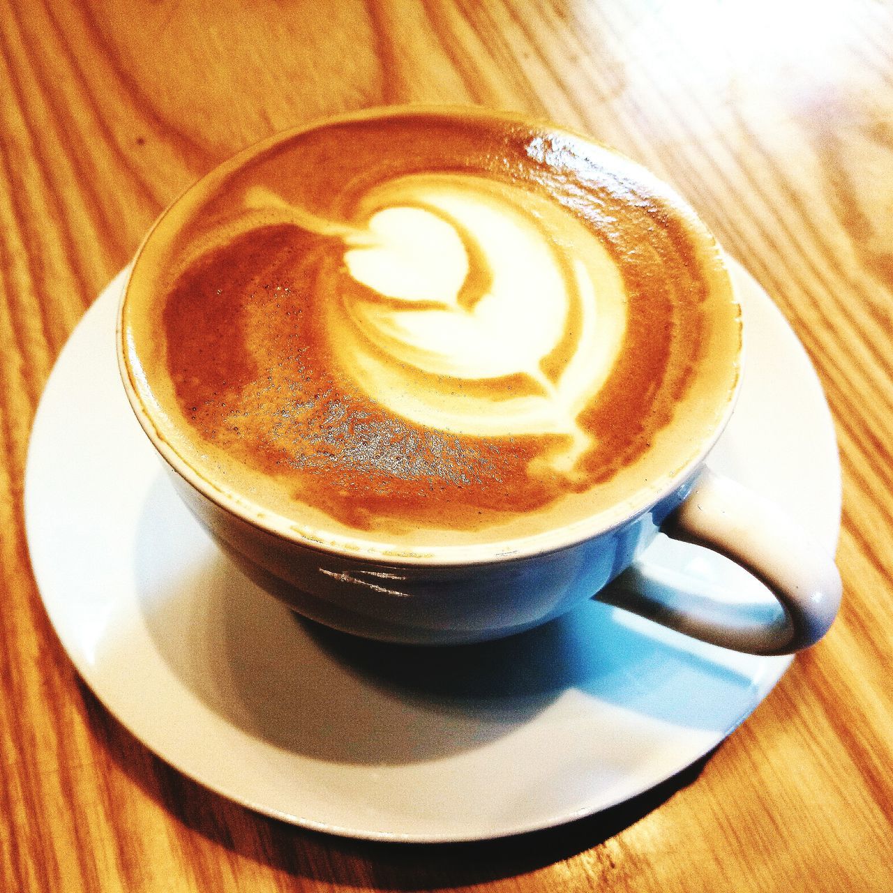 CLOSE-UP OF COFFEE CUP ON TABLE