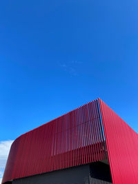 Low angle view of modern building against clear blue sky