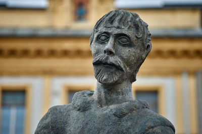 Close-up of statue against old building