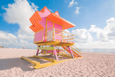 Lifeguard hut on beach against sky