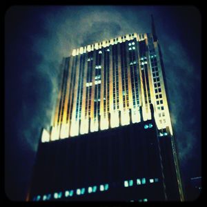 Low angle view of illuminated building against sky at night