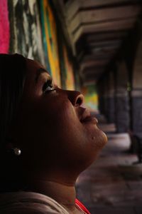 Close-up portrait of young woman looking away