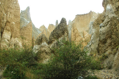 Panoramic view of rocky mountains against clear sky