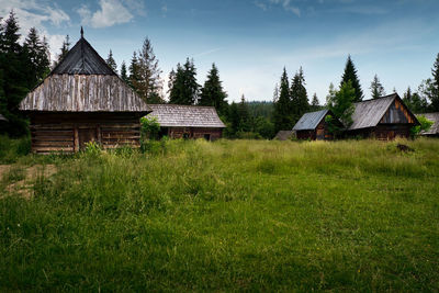 Built structure on field against sky