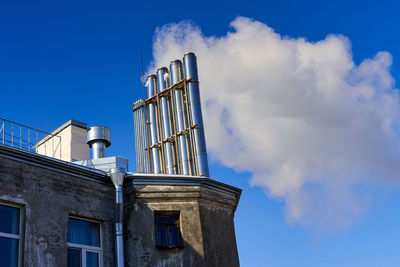 Low angle view of smoke stack against sky