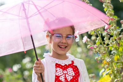 Portrait of a smiling beautiful little girl with umbrella