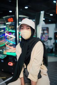 Portrait of young woman standing in store