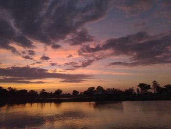 Scenic view of lake against orange sky