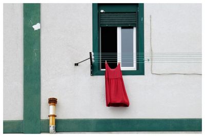 Red dress hanging on the clothesline.