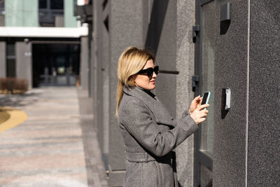 Female entering secret key code for getting access and passing building using application on mobile