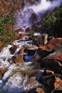 Scenic view of waterfall against sky