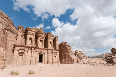 Wide andgle shot of the monastery in petra with blue sky and clouds