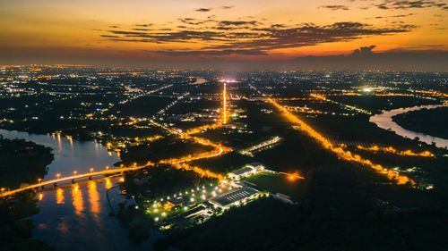 High angle view of illuminated buildings against sky during sunset