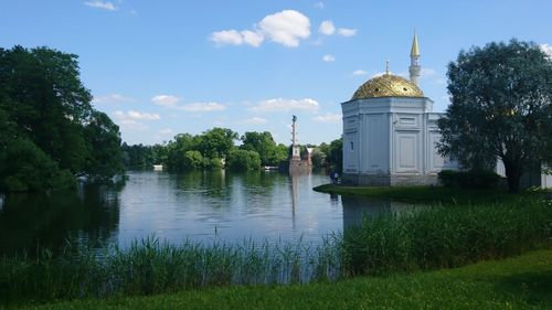 Building by lake against sky