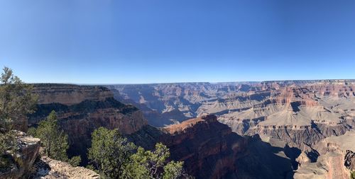 Panoramic view of landscape against clear blue sky