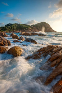 Scenic view of rocks in sea against sky