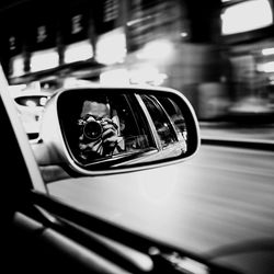 Reflection of side-view mirror of car