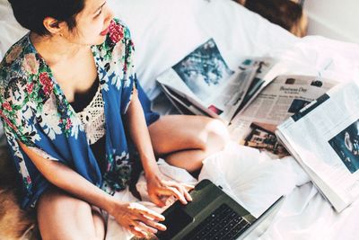 High angle view of woman using laptop while sitting at home