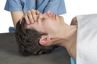 Close-up of man lying on hand