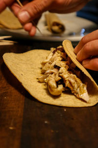 Close-up of person preparing food on table