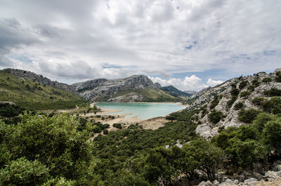Scenic view of lake and mountains against sky