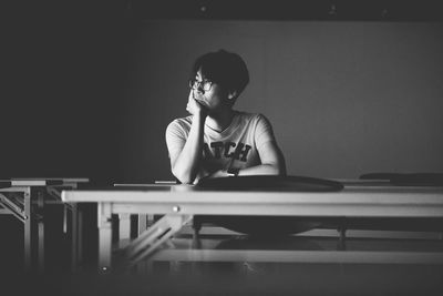 Full length of a boy sitting on table