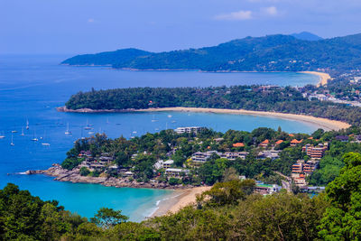 High angle view of sea and cityscape against sky