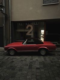 Car parked on street against buildings in city