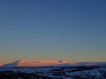 Scenic view of snow covered mountains