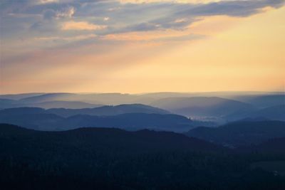 Scenic view of silhouette mountains against sky during sunset