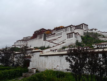 Potala palace against cloudy sky