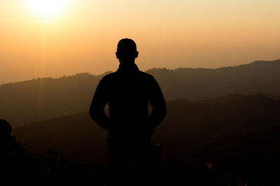 Man silhouette who were standing and watching the sunrise in the morning.