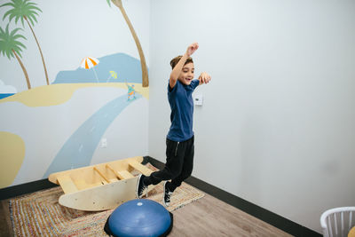 Smiling boy jumps from a sensory bouncer