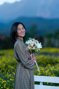 Beautiful woman standing against blue sky