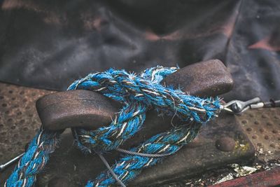 Close-up of blue rope tied on cleat