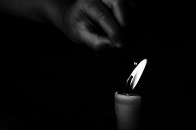 Close-up of human hand against black background