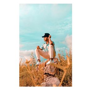 Digital composite image of woman on rock against sky