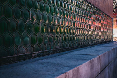 Stack of metal fence against building