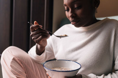 Midsection of woman holding ice cream